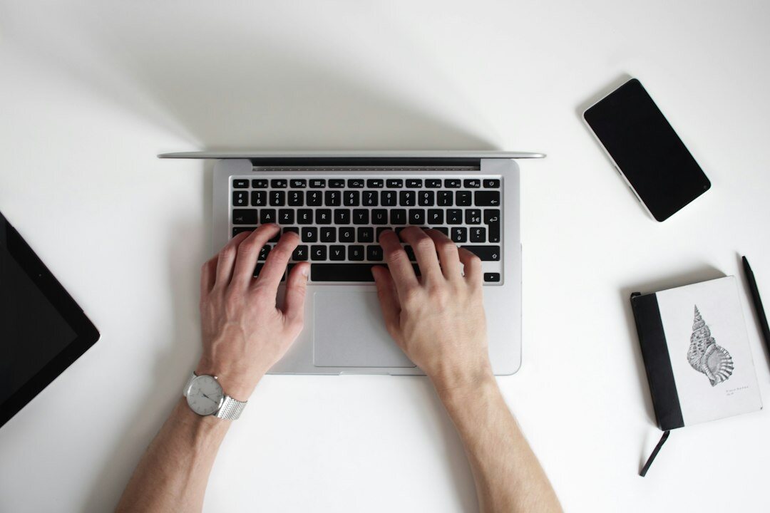 writer typing on laptop